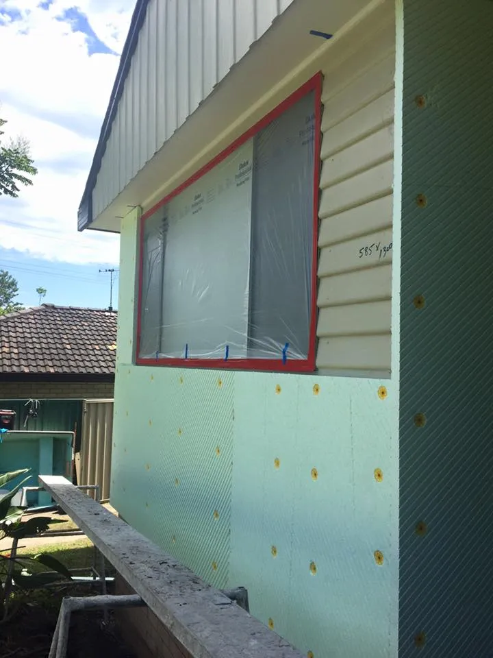 Foam board render system fixed to a house wall before rendering
