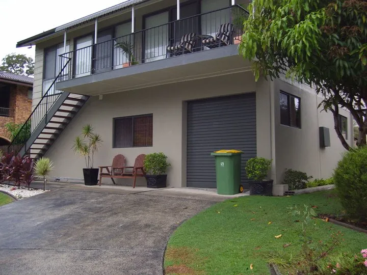 Two-storey home with a smooth hand-finished plaster render in soft neutral tones